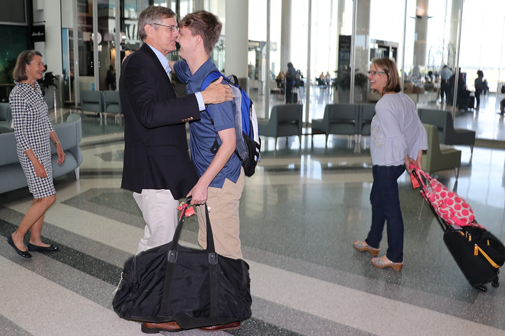 Ben Hagood and Thomas Hayes meeting for the first time at the airport