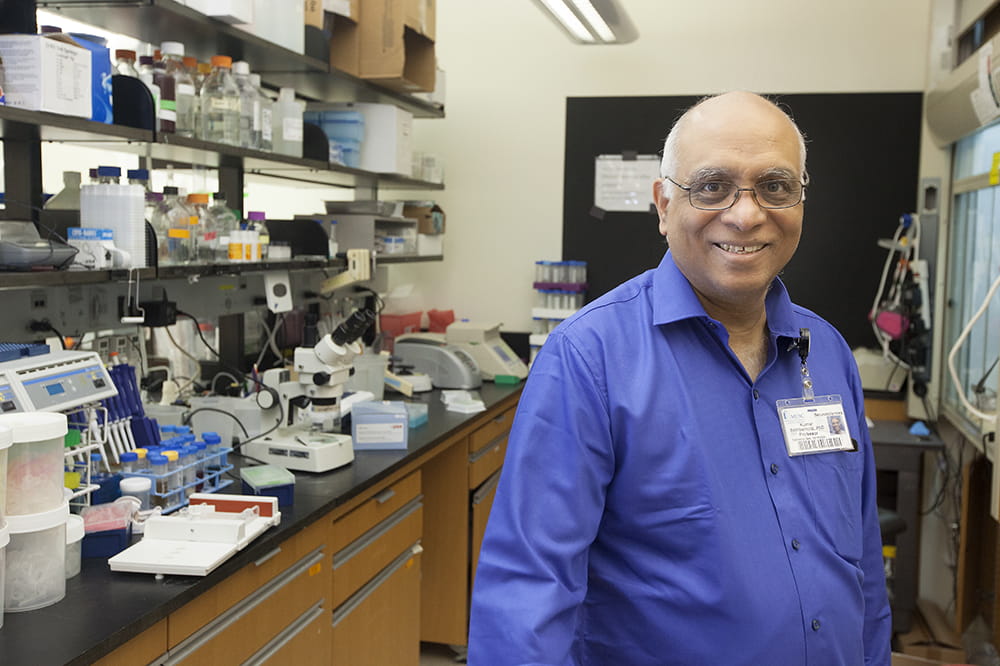 Kumar Sambamurti poses in his lab