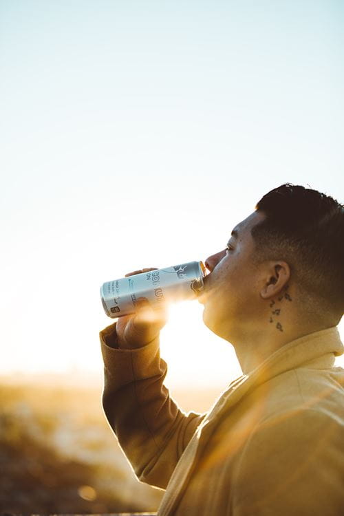 man drinking an energy drink