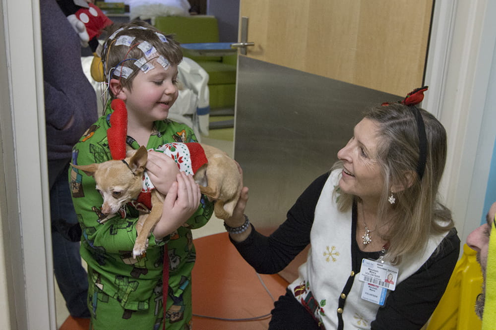 Five-year-old Sullivan Cole holds Fierce, aka "Max," as Marybeth Myers and the Grinch look on. Photos by Sarah Pack