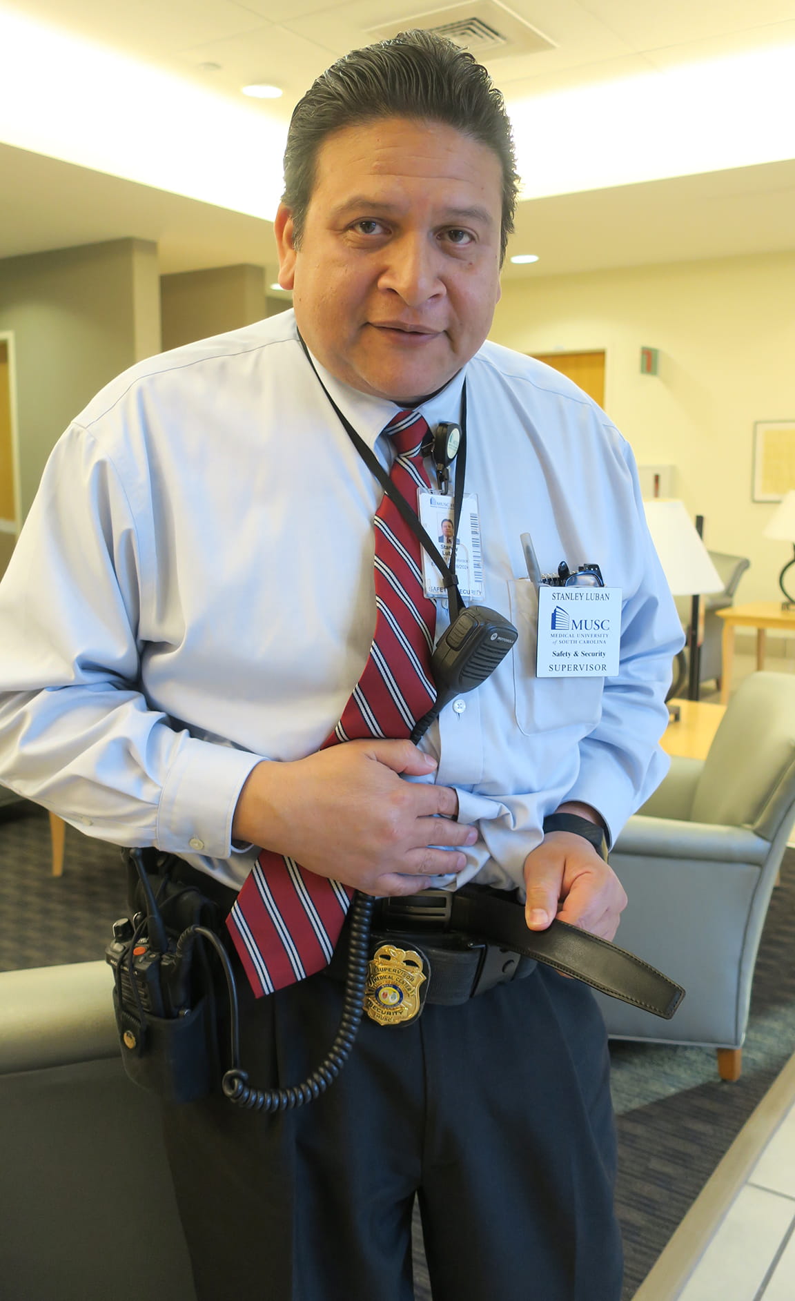 Safety and Security's Stanley Luban holds out his pants to show weight loss