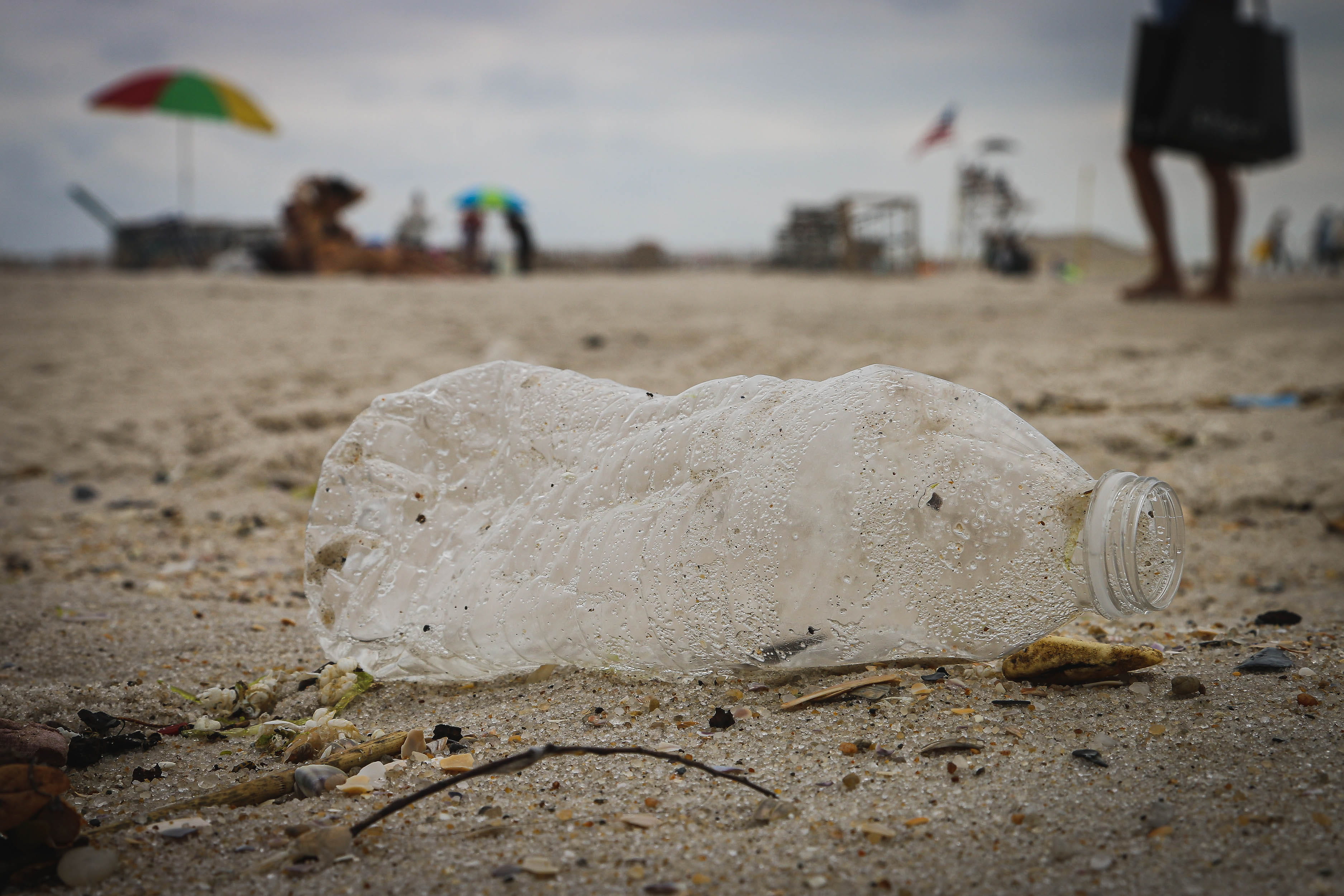 Empty plastic water bottle lying on beach