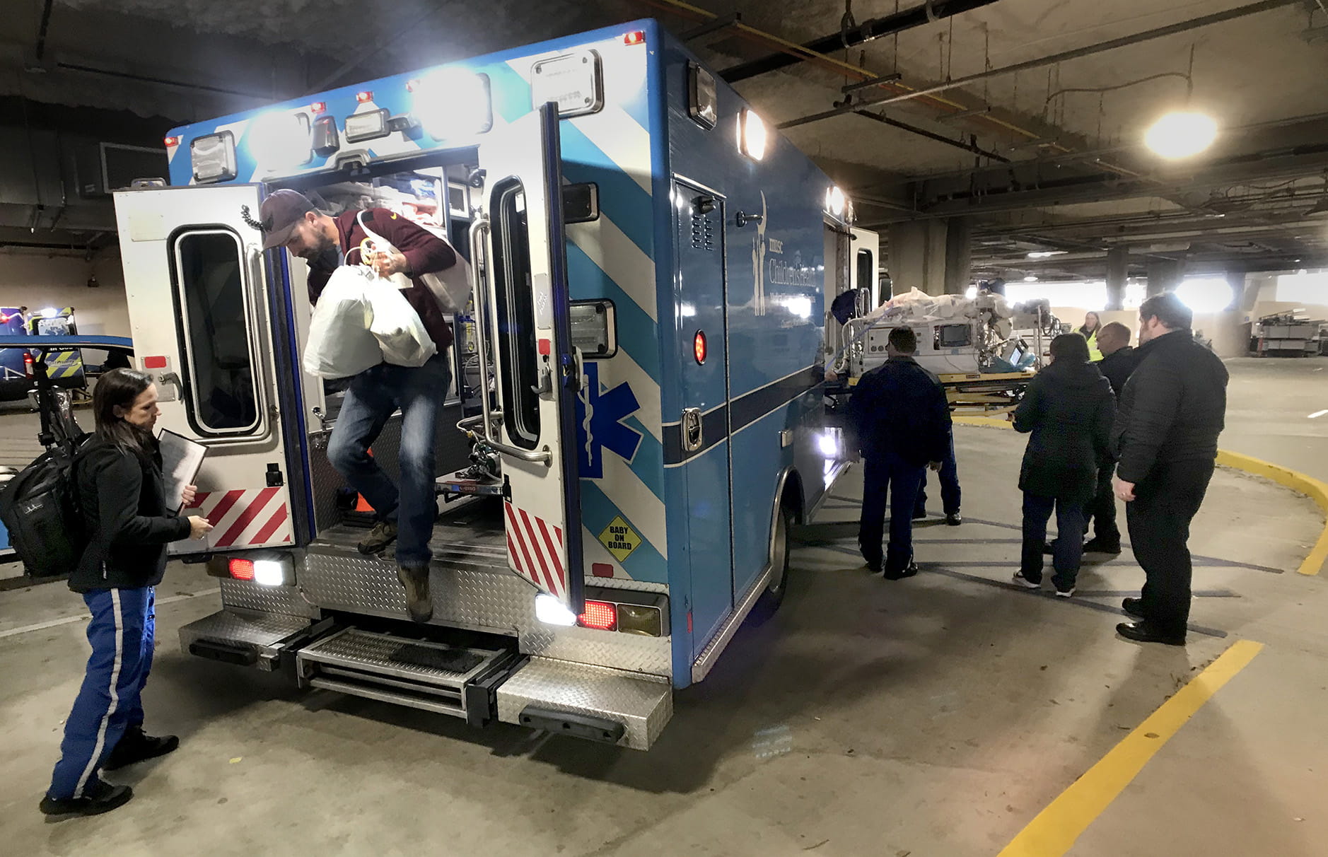 man and baby exiting ambulance
