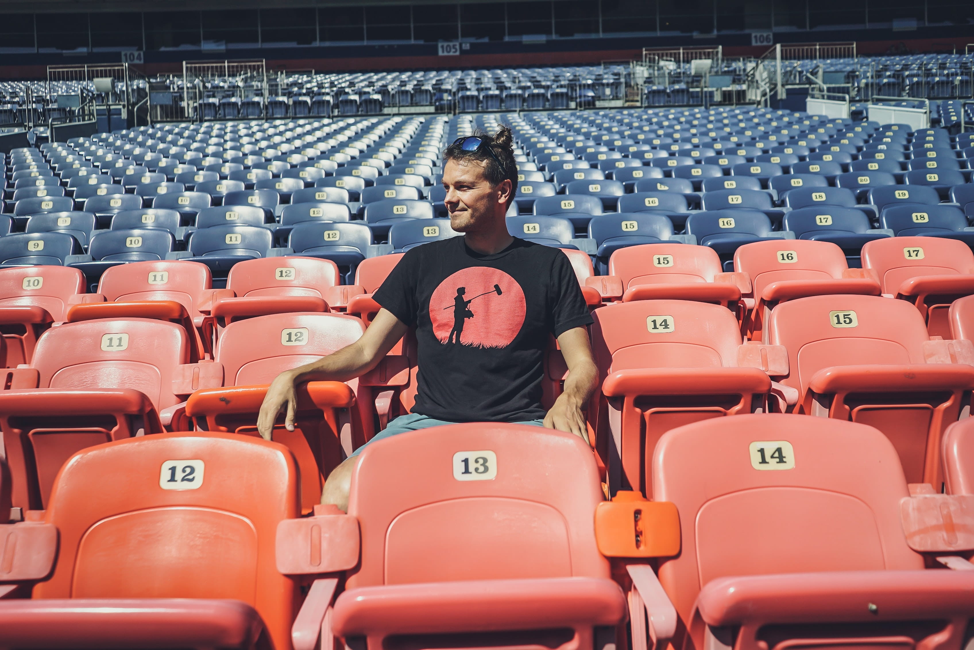 Man sitting alone in an empty stadium