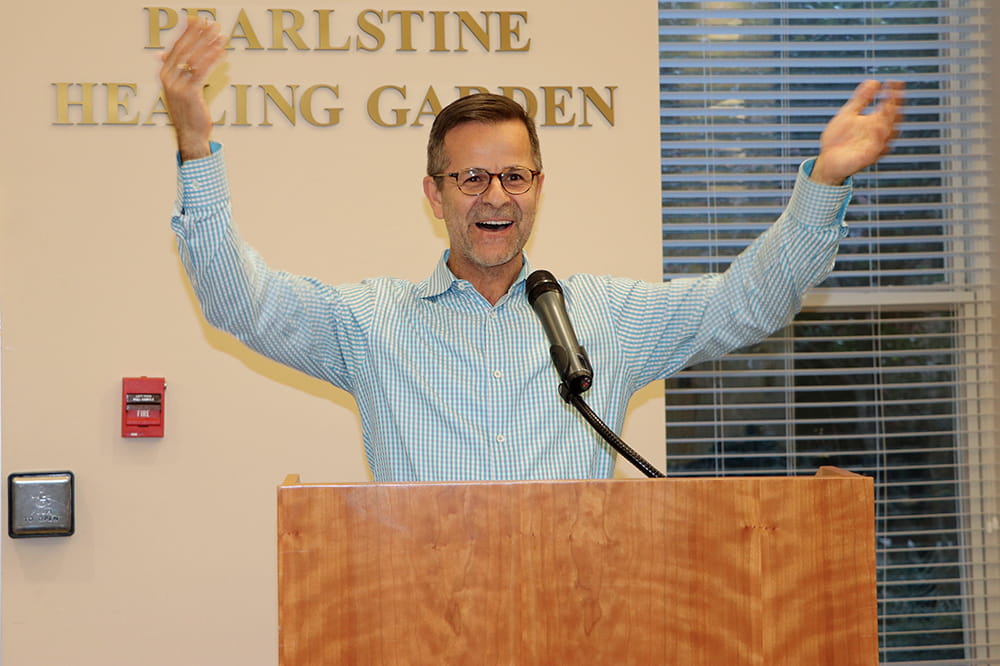 A man stands at podium during speech. 
