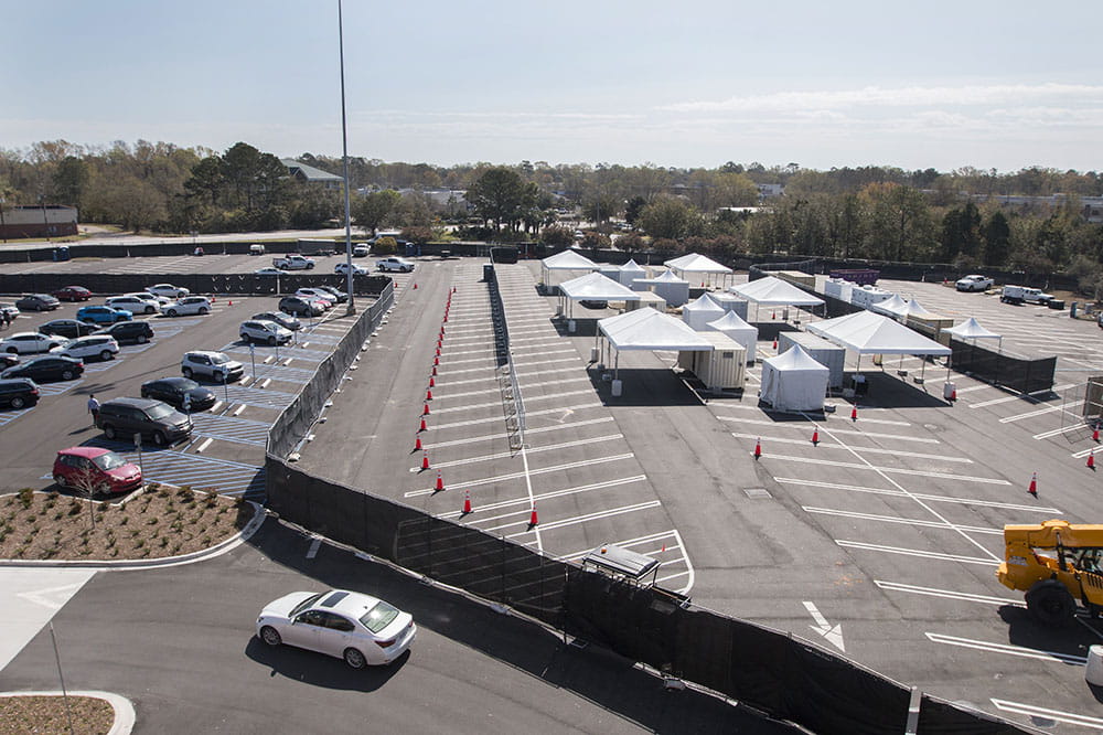 Tents in a mall parking lot where people can drive up and be swabbed for COVID-19 testing.