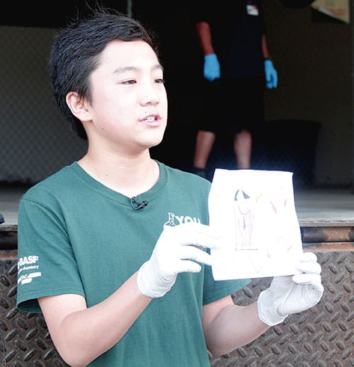 Buist Academy student Harry Ding shows off a hand-drawn picture from a child recognizing the need of supplies needed by the Lowcountry medical community in treating COVID-19.