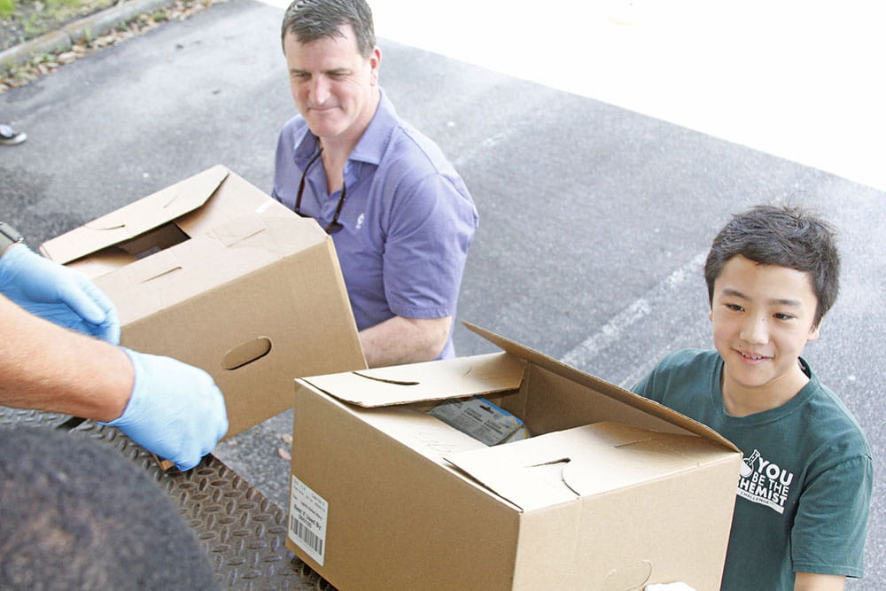 Cardiologist Dr. Jeff Winterfield and Buist Academy's Harry Ding donated boxes of medical supplies to the Medical Supply Collection site on March 24. 