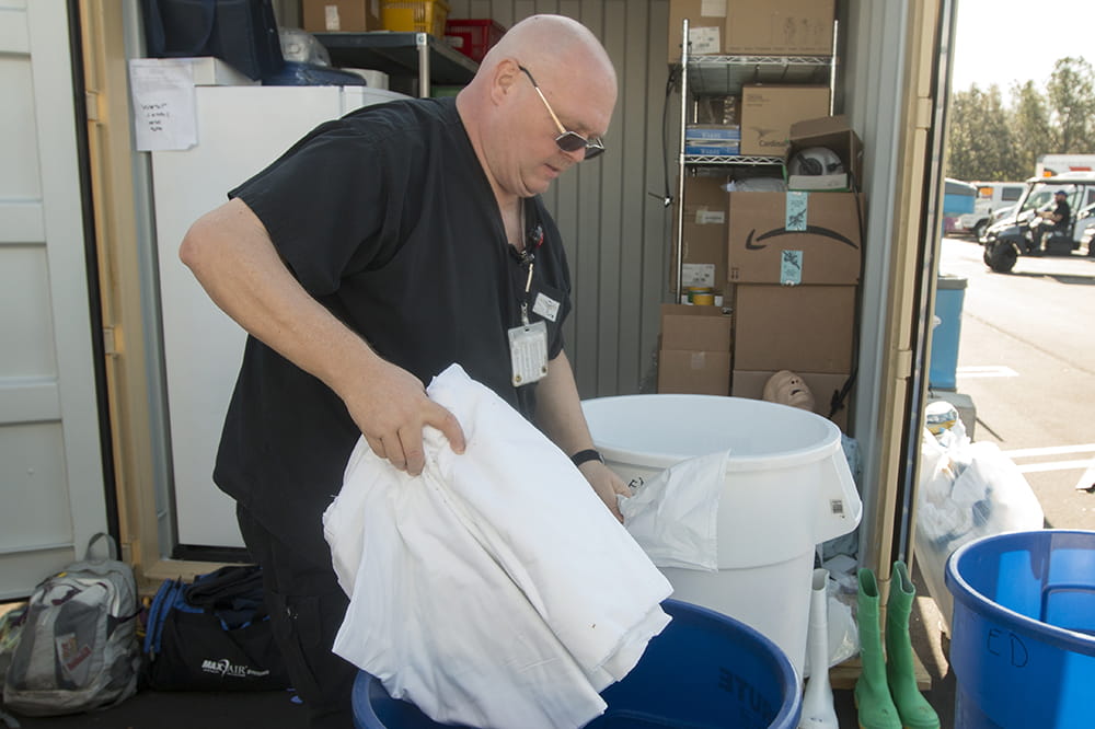 Johan Zamoscianyk sorts supplies at the drive-through collection site