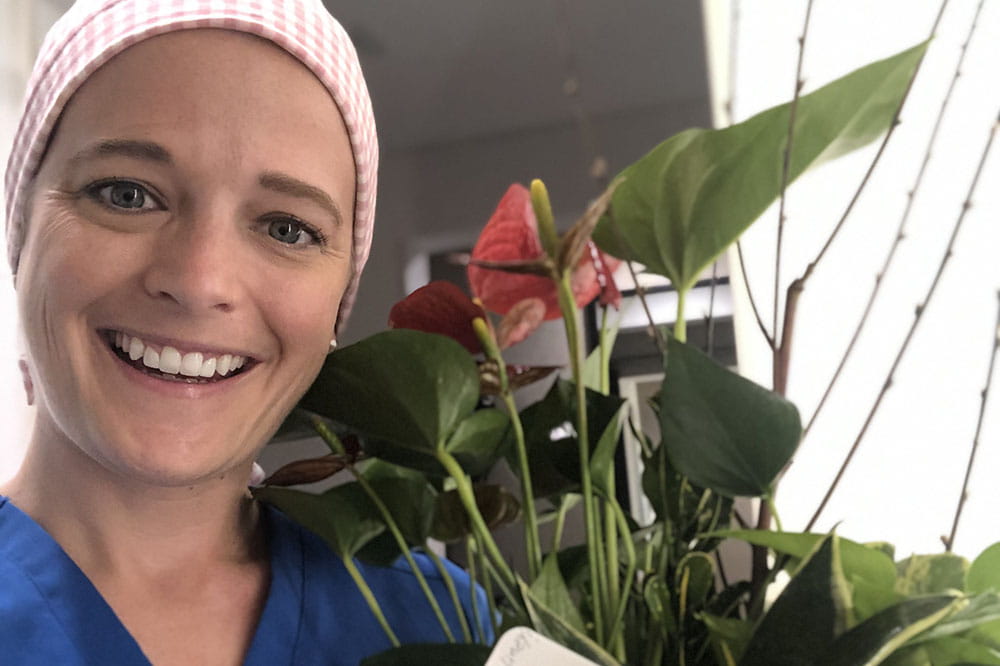 MUSC Health nurse Caroline Wright holding flowers in New York where she is taking care of COVID patients.