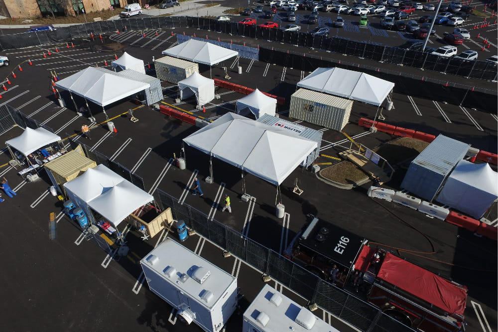an aerial shot showing the tents set up in the mall parking lot for the drive through specimen collection site. 