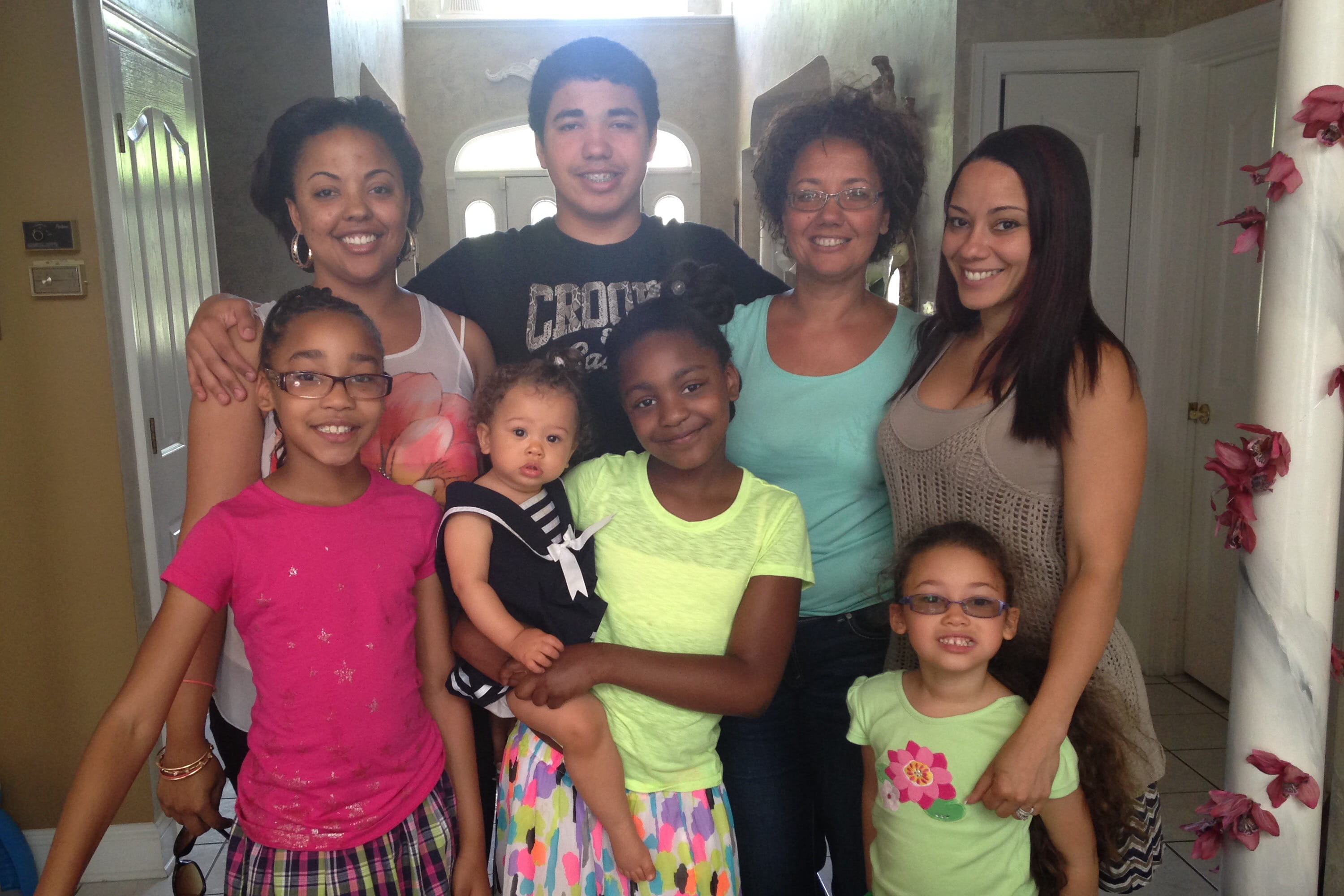 Marcelaine Reneau and her family posing for a portrait inside on Mother's Day in 2015.
