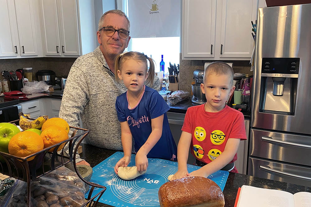 David Turner and his kids baking bread in their kitchen