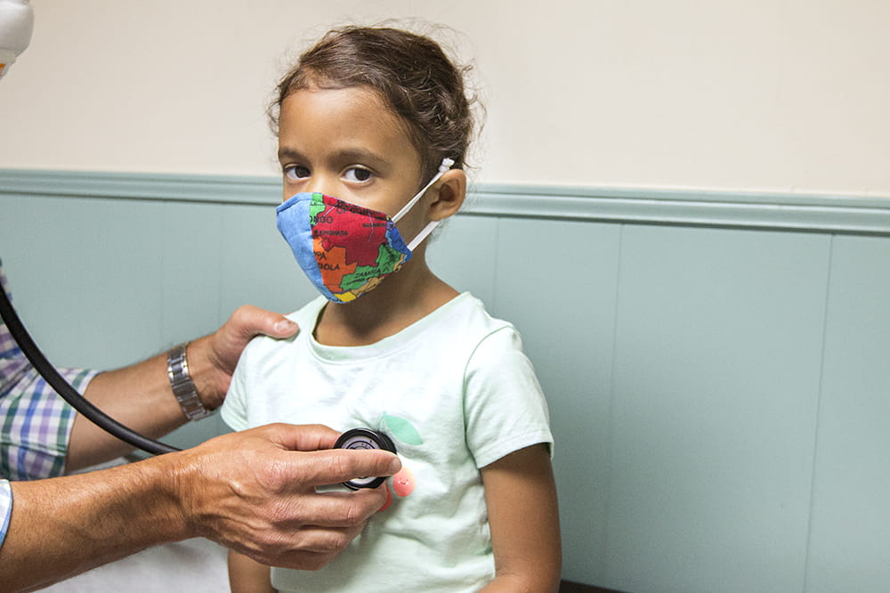 Adeline Pack, age 4, wearing a mask at a check-up. 