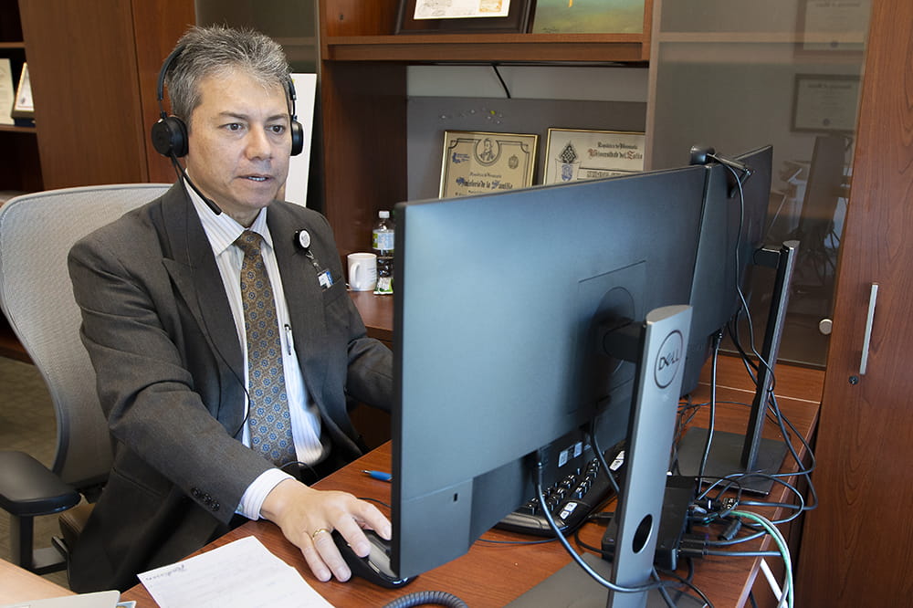 Dr. Hermes Florez working on computer