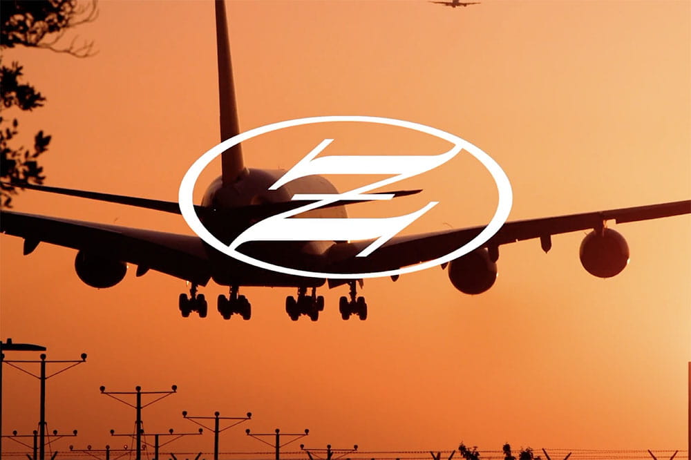 Airplane with Zeus logo over it.
