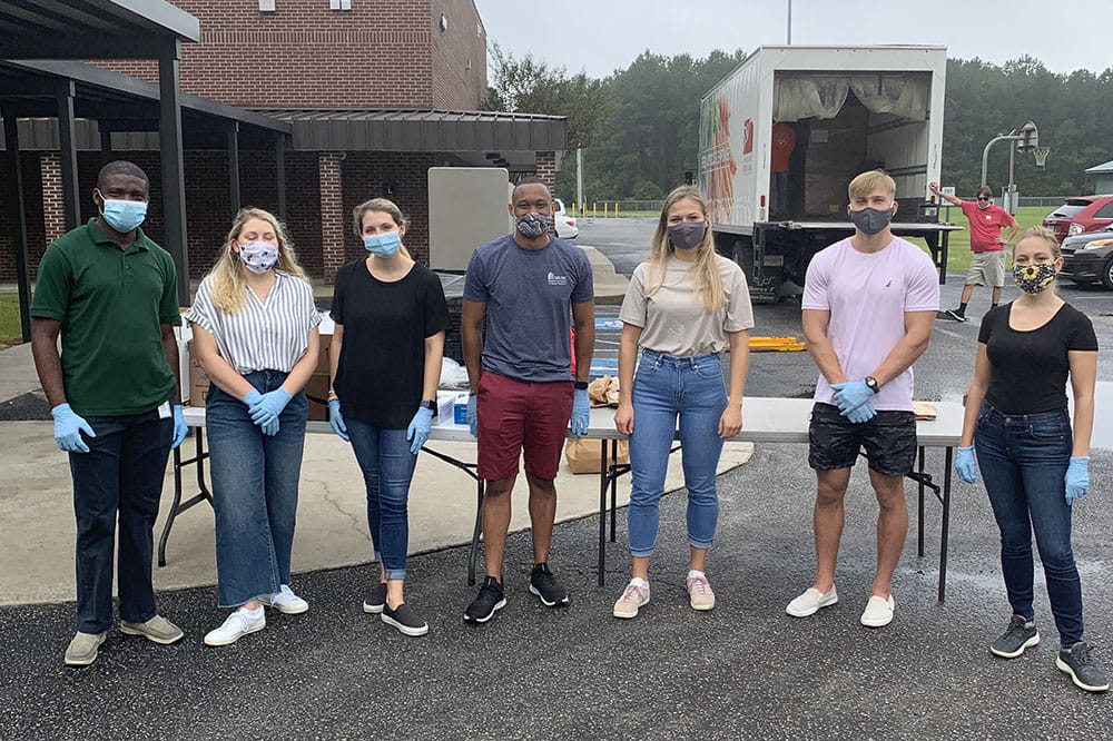 Medical students working for CARES Clinic pose for photo wearing masks