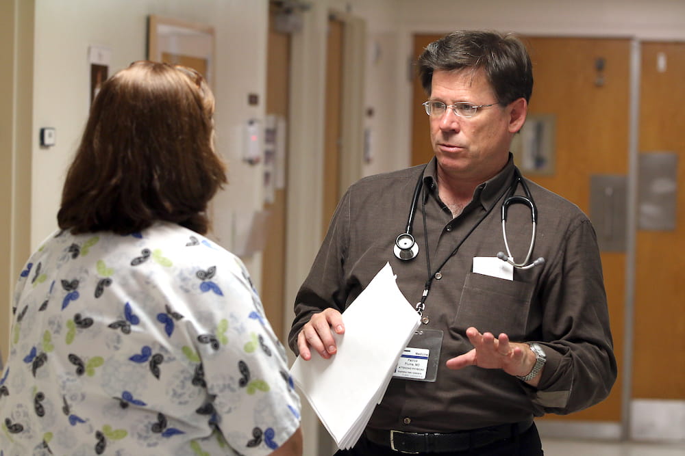 Dr. Patrick Flume of the Medical University of South Carolina in discussion with a colleague.