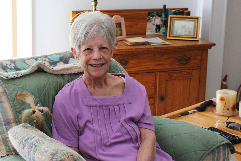 Janet Smith sits in her home