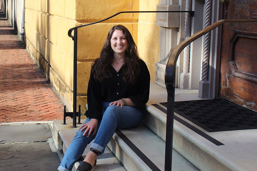 Kelly Bulak sits on the steps outside the Aiken Rhett House in Charleston