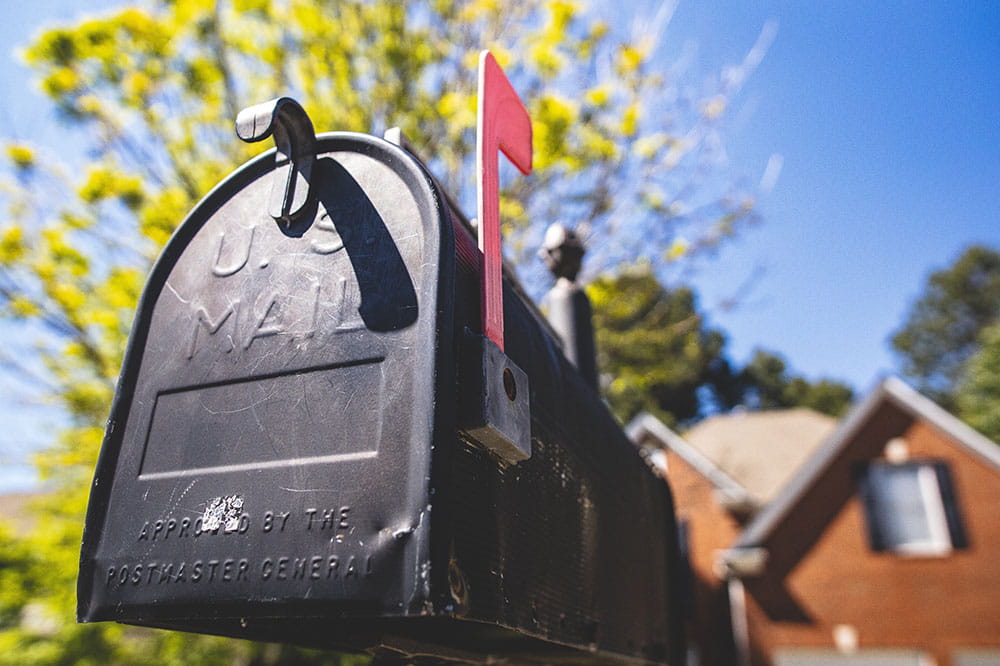 Mailbox in front of brick house