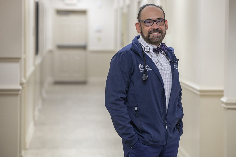 Dr. Zayas poses in the hallway at a clinic