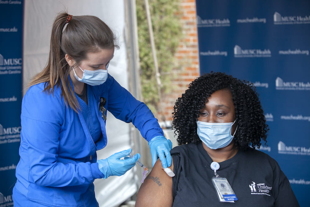 Woman getting vaccine in arm
