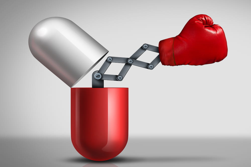 Illustration of a boxing glove coming out of a pill. Licensed from istockphoto.com. Illustration by Wildpixel.