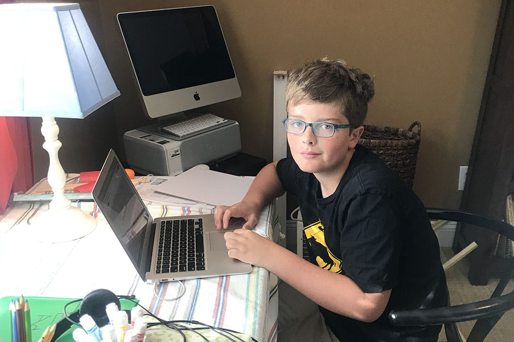 Eli Adams, age 11, attends school virtually during the coronavirus pandemic.