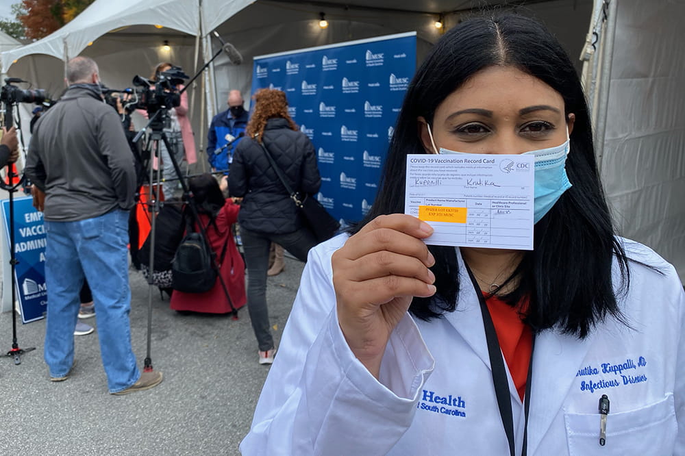 Dr. Kuppalli showing her vaccine card
