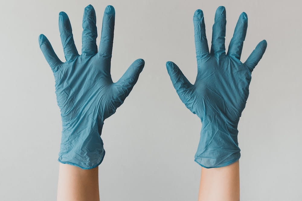 Pair of hands wearing surgical gloves