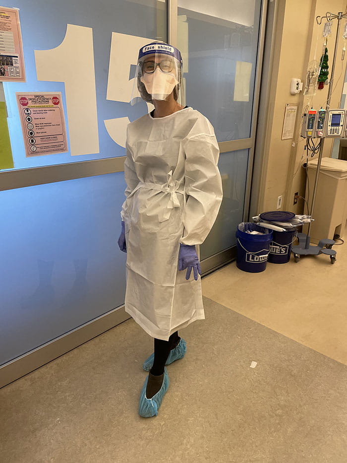 Dr. Jessica Lewis in PPE preparing to see a patient.