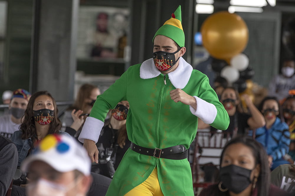 Buddy the Elf saunters down the aisle toward the stage at Match Day celebrations