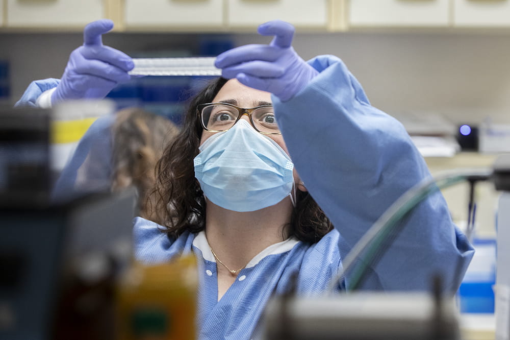 Medical technologist Kristen Maurer checks SARS-CoV-2 positive samples, preparing them to be sequenced.