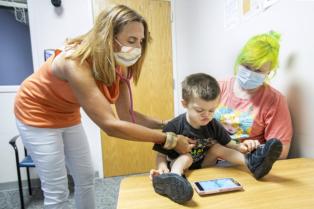 Angela C. LaRosa, M.D. listens to Freddie Taylor's heart, while his mom, Joanne Taylor, holds him at a recent doctor's visit. 