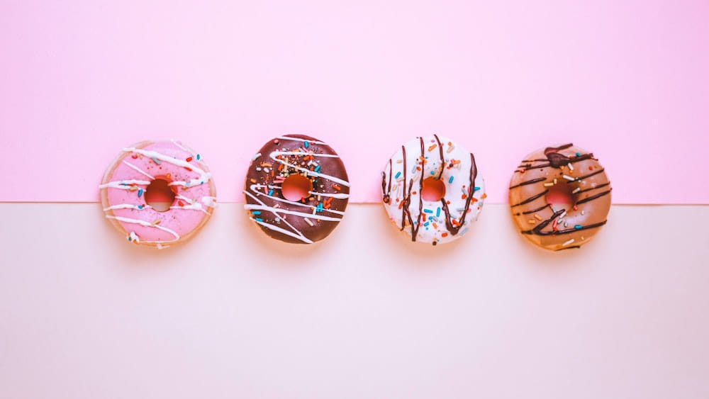 A line of four different glazed doughnuts