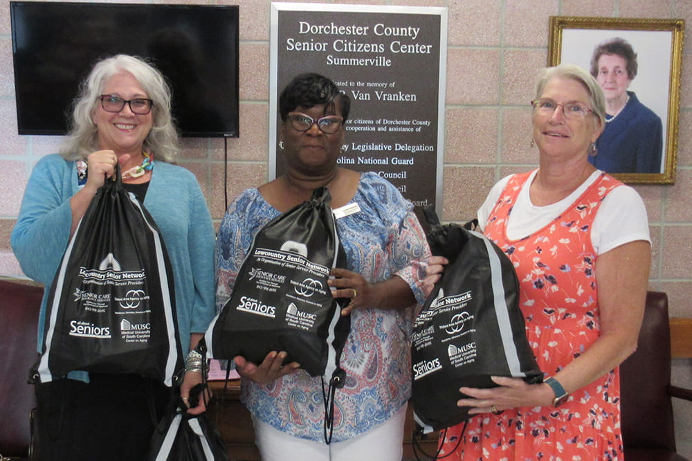  Lynn Dierke, Cynthia Footman and Jean Ott hold bags of supplies for homeless seniors. Dierke is with the Lowcountry Senior Network. Footman and Ott are with a senior center.