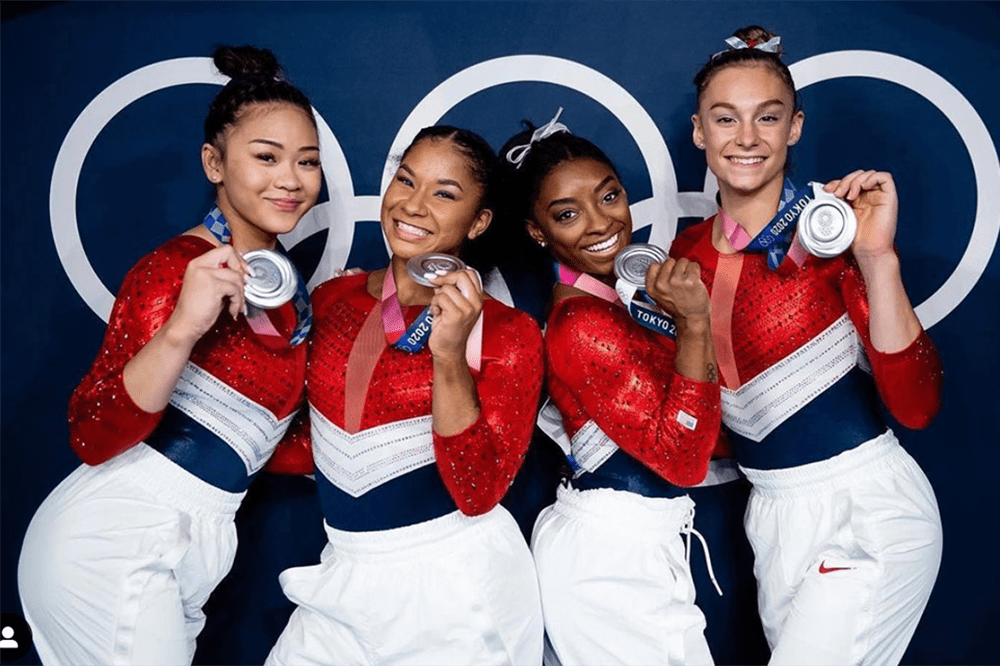Simone Biles with fellow gymnasts and silver medals