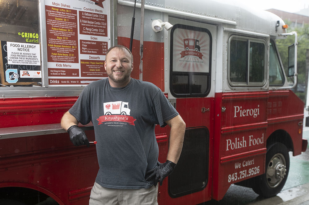 Victor Krupka, who used brain stimulation to help him quit smoking, stands with his food truck.