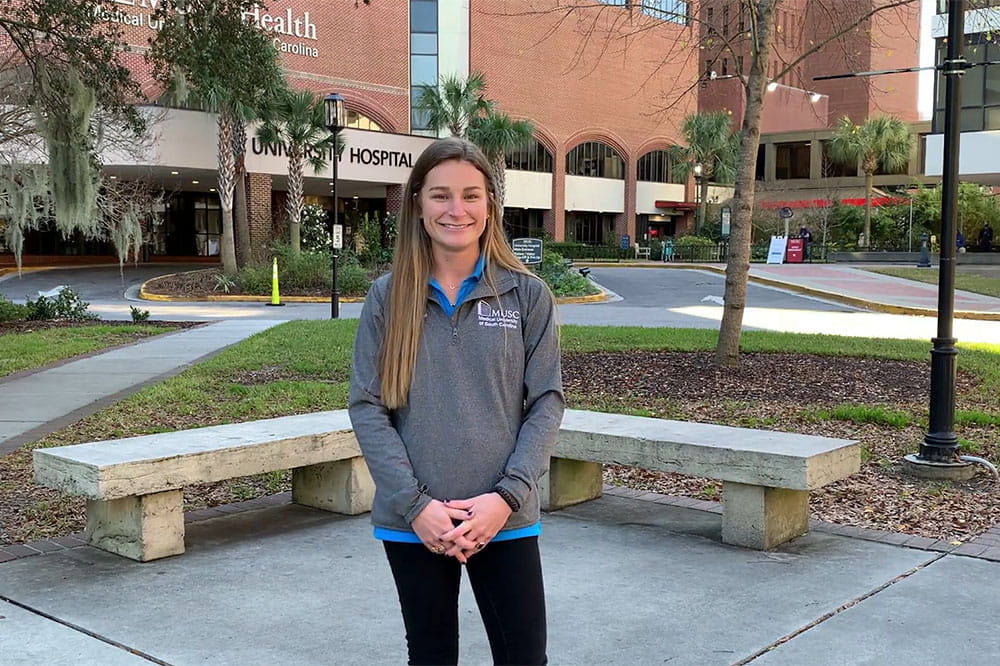 Occupational Therapy Scholarship recipient Bailey Bullock stands in front of the hospital.