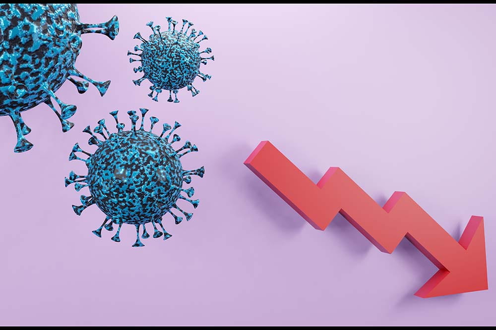 Illustration of the coronavirus with a red arrow pointing down.