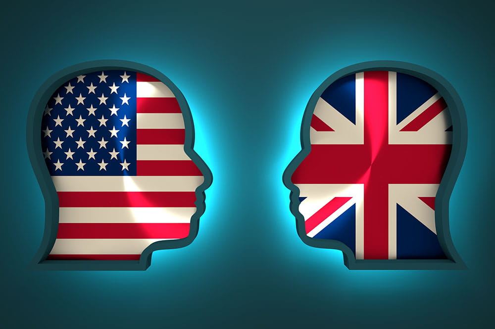 outline of two heads with United States and United Kingdom flags inside them