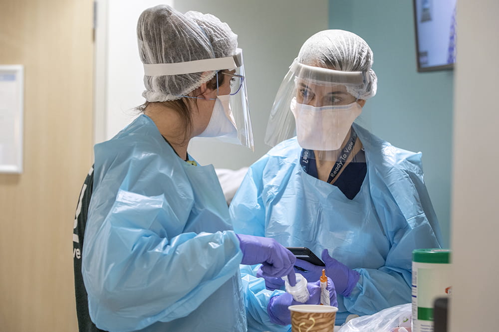 Alexandra Rosol, ADN, RN, left, and Elizabeth Mack, M.D., right, discuss a patient at the pediatric intensive care unit at the MUSC Shawn Jenkins Children's Hospital.