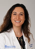 headshot of a doctor with long brown hair