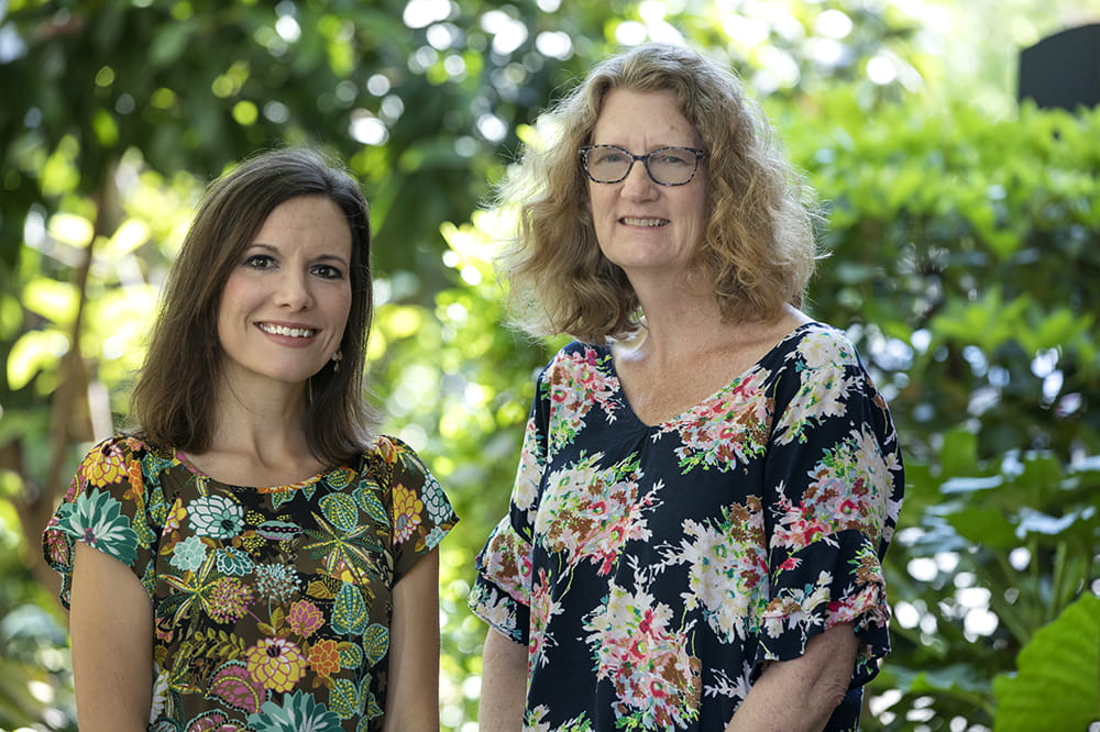 Dr. Angela Malek and Dr. Kelly Hunt standing in a garden