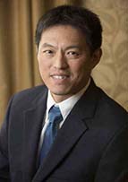 Headshot of Dr. John Lin. He is wearing a suit and tie.