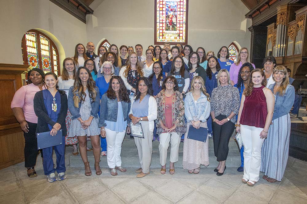 Unit Nurses of the Year stand in a large group in St. Luke's Chapel.