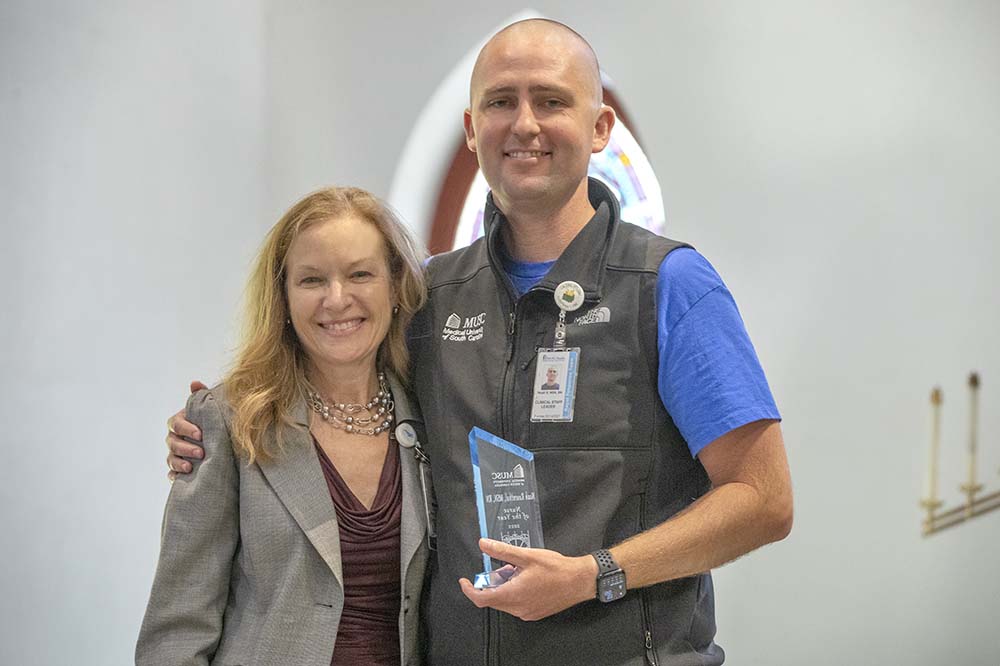 Chef nursing officer Patti Hart stands with Nurse of the Year Noah Rosenthal in St. Luke's Chapel.