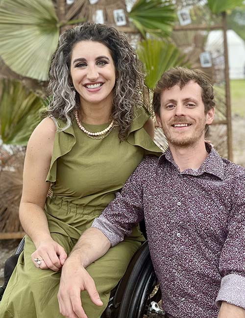 College of Medicine graduate Julia Rodes and her husband Jared. They are seated and smiling.