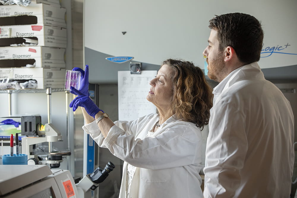 Dr. Paula Traktman (left) and graduate student Conor Templeton in the laboratory.